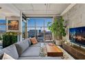 Bright living room boasts a sectional sofa, large windows, and city views at 353 E Bonneville Ave # 1302, Las Vegas, NV 89101