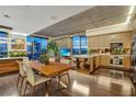 A spacious living room with hardwood floors, floor-to-ceiling windows, and an open-concept kitchen at 353 E Bonneville Ave # 1302, Las Vegas, NV 89101