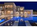 Luxurious outdoor living space featuring a sparkling pool, modern lounge chairs, and elegant architecture at 3740 Caesars Cir, Las Vegas, NV 89120