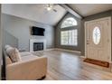 Bright living room featuring a fireplace, large window, and neutral tones at 3811 Twinkle Star Dr, Las Vegas, NV 89115