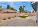 Private backyard featuring desert landscaping, artificial turf, and a concrete patio at 4205 Caliper Dr, Las Vegas, NV 89110