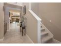 Inviting foyer with staircase, neutral tones, and views of the outdoor patio at 4289 Sunrise Flats St, Las Vegas, NV 89135