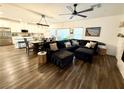 Open-concept living room and kitchen with hardwood floors, modern lighting, and stainless steel appliances at 600 N Carriage Hill Dr # 1082, Las Vegas, NV 89138
