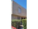 Two-story townhome featuring a secure front door and a window with privacy bars for added safety at 6299 W Washington Ave, Las Vegas, NV 89107