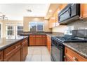 Kitchen boasts granite countertops, stainless steel appliances, and well-lit tile flooring at 7098 Seabirds Pl, North Las Vegas, NV 89084