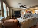 Open living room featuring hardwood floors, recessed lighting, and large windows that let in natural light at 8396 Waylon Ave, Las Vegas, NV 89178