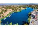 Scenic aerial view showcasing the community's waterfront homes along a serene lake at 8404 Shore Breeze Dr, Las Vegas, NV 89128