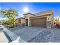 Charming single-story home featuring a well-manicured yard, two-car garage, and paver driveway at 8797 Pinley Spring St, Las Vegas, NV 89113
