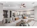Spacious living room featuring modern furnishings and lots of natural light from surrounding windows at 8797 Pinley Spring St, Las Vegas, NV 89113