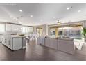 Bright, open-concept living space with hardwood floors, recessed lighting and backyard view at 8797 Pinley Spring St, Las Vegas, NV 89113