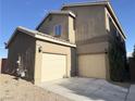Beige two-story home featuring a two-car garage and low maintenance landscaping at 9138 Hermosa Valley St, Las Vegas, NV 89178