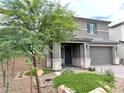 Stylish home with a stucco exterior, desert landscaping, and a two-car garage at 929 Hunter Shores Ave, North Las Vegas, NV 89084