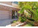 Beautiful front entrance with a brick archway and decorative landscaping at 9823 Belle Marie Ct, Las Vegas, NV 89141