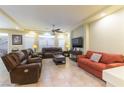 Open-concept living room with leather seating and bright natural light at 9823 Belle Marie Ct, Las Vegas, NV 89141