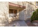 Inviting front entryway features a secure metal security gate and small shrub at , Henderson, NV 89011
