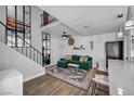 Bright and airy living room with stairs, contemporary decor and wood-look floors at 1025 Willow Tree Dr # B, Las Vegas, NV 89128