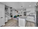 Open-concept layout showcases the kitchen, living room, and staircase with sleek black railings at 1025 Willow Tree Dr # B, Las Vegas, NV 89128