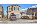Charming two-story home featuring a neatly paved driveway, a well-maintained lawn, and an attached two-car garage at 1168 Aspen Cliff Dr, Henderson, NV 89011