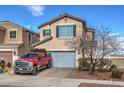 Charming two-story home featuring a neatly paved driveway, a well-maintained lawn, and an attached two-car garage at 1168 Aspen Cliff Dr, Henderson, NV 89011