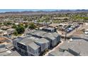 Drone image of gray, modern townhouses featuring a landscaped community in a residential neighborhood at 143 Aqua Commons Ln, Henderson, NV 89015