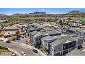 A high angle image of modern townhouses in a landscaped community with mountain views at 143 Aqua Commons Ln, Henderson, NV 89015