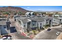 Aerial shot of modern townhouses with two-car garages, neutral toned exterior, and mountain views at 143 Aqua Commons Ln, Henderson, NV 89015