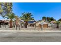 Charming home with a gated yard, mature palm trees, and a well-manicured front yard at 1940 Canterbury Dr, Las Vegas, NV 89119