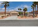 Charming single-story home with desert landscaping, mature palm trees and three car garage at 2078 Wildwood Lake St, Henderson, NV 89052