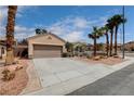 Inviting single-Gathering home with desert landscaping and a driveway leading to a two-car garage at 2078 Wildwood Lake St, Henderson, NV 89052