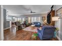 Spacious living room boasts hardwood floors and ample natural light with views of the kitchen at 2078 Wildwood Lake St, Henderson, NV 89052