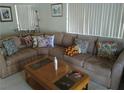 Comfortable living room featuring a large sectional sofa and bright, natural light from the window at 2148 Hidden Ranch Ter, Henderson, NV 89052