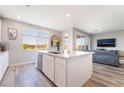 Bright and airy kitchen with large island, white cabinets, stainless steel appliances, and modern finishes at 23 Strada Barbera, Henderson, NV 89011