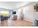 Cozy living room with sliding glass doors, stylish furniture, and wood-look floors at 23 Strada Barbera, Henderson, NV 89011