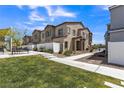 View of townhome exteriors with community green spaces, manicured landscaping, and walkways at 236 Callen Falls Ave # 1211, Henderson, NV 89011