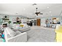 Bright, open living room featuring a stone fireplace, ceiling fan, and gray rug at 2426 La Pluma St, Henderson, NV 89014