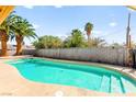Refreshing backyard pool with a concrete surround and privacy wall, perfect for summer relaxation at 2426 La Pluma St, Henderson, NV 89014