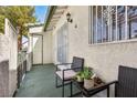 Relaxing front patio with seating area and wrought iron security door at 2460 Old Forge Ln # 48, Las Vegas, NV 89121