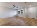 Bright living room with hardwood floors, ceiling fan, and natural light from windows at 2871 Tanager Hill St, Henderson, NV 89044