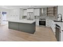 Modern kitchen with white cabinets, stainless appliances, and a center island at 2894 Matese Dr, Henderson, NV 89052