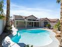 This backyard features a sparkling pool and an expansive covered patio at 2894 Matese Dr, Henderson, NV 89052