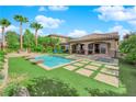 Beautiful backyard with a sparkling pool, spa, and lush green turf, ideal for outdoor living and entertaining at 2901 Josephine Dr, Henderson, NV 89044