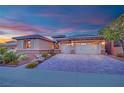 Charming home exterior featuring a manicured lawn, beautiful landscaping, and a three-car garage at 2901 Josephine Dr, Henderson, NV 89044