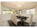 This dining room features neutral walls, plenty of natural light, and is staged for a dinner party at 3163 Biccari Ave, Henderson, NV 89044