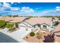 Beautiful home featuring a two-car garage and tasteful landscaping in a desert community at 3278 Turning Bridge St, Las Vegas, NV 89135