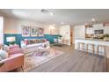 Bright, open-concept living room with modern decor, dining area, and kitchen at 5011 Sage Mesa Ave # Lot 143, Las Vegas, NV 89139