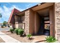 The exterior view showcases a two-story condo featuring stone accents and a covered walkway at 5020 Indian River Dr # 424, Las Vegas, NV 89103