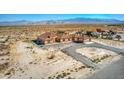 Spacious desert property featuring a home with a terracotta roof, circular driveway, and RV parking at 5700 E Carter Ln, Pahrump, NV 89061