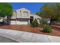Charming two-story home featuring an attached three-car garage and well-maintained landscaping at 614 Ravenglen Dr, Las Vegas, NV 89123