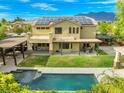 Spacious backyard with pool, patio, and solar panels, ideal for outdoor living and entertaining at 6335 Iginlas Goal Ave, Las Vegas, NV 89131