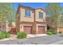Two-story home with attached two-car garage, manicured landscaping, and desert foliage at 637 Taliput Palm Pl, Henderson, NV 89011